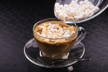 Cup of coffee with tasty marshmallow dessert