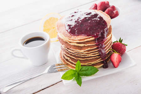 delicious breakfast with pancake with strawberry and coffee cup