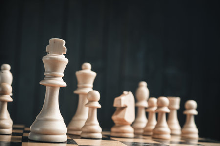 Chess pieces on the board. Black wood background behind.