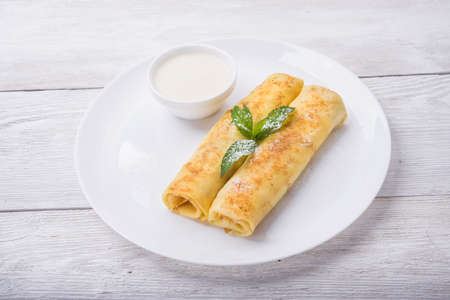 pancakes with cottage cheese and gren mint on white plate backgroundの写真素材