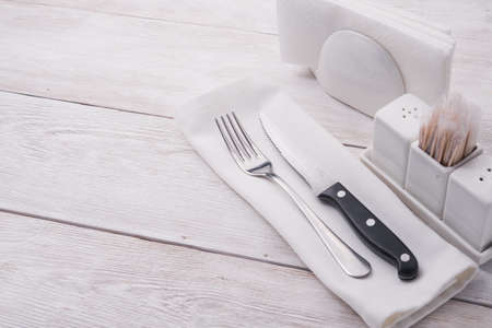 metal fork and knife on wooden tableの写真素材