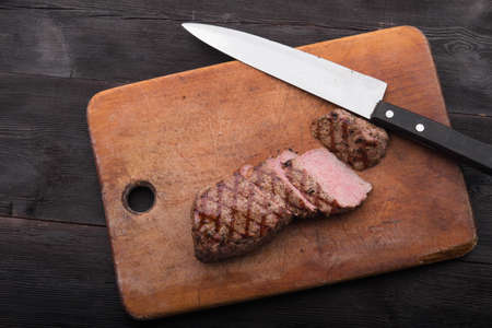 beef steak on with fresh salad on stone board backgroundの写真素材