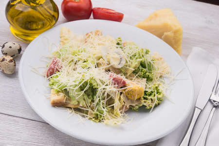 Caesar salad on white wooden tableの写真素材