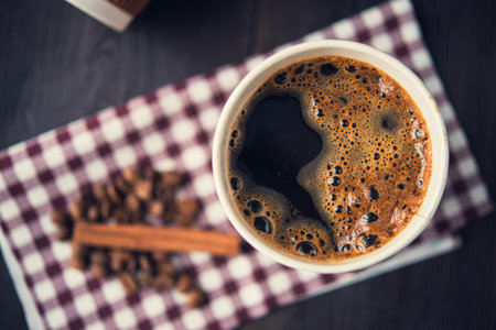 paper cup of hot coffee on wooden tableの写真素材