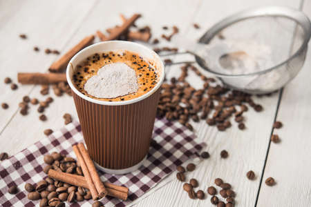 paper cup of hot coffee on wooden tableの写真素材
