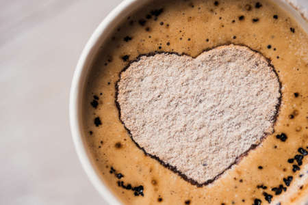 tasty cup of cappuccino on white wooden tableの写真素材