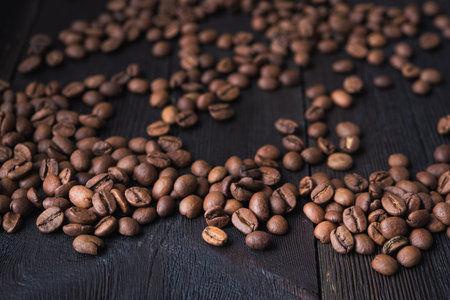 closeup of coffee beans on wooden black table