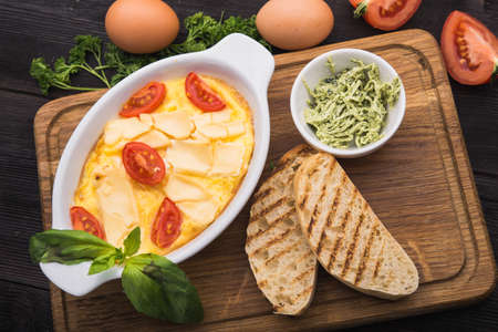 delicious and hearty breakfast of omelet and toastの写真素材