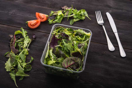 close up of green salad arugula on wood backgroundの写真素材