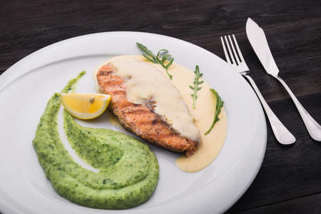 salmon steak with sauce in a restaurantの写真素材