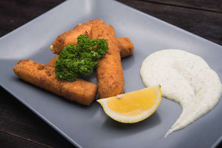cheese sticks with parsley and lemon in restaurantの写真素材