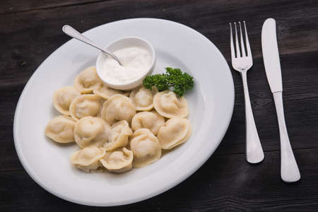 homemade tasty pelmeni with sour cream in restaurantの写真素材