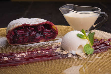sweet strudel with ice cream ball in restaurantの写真素材