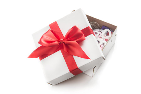 white gift box with red ribbon bow isolated on white background