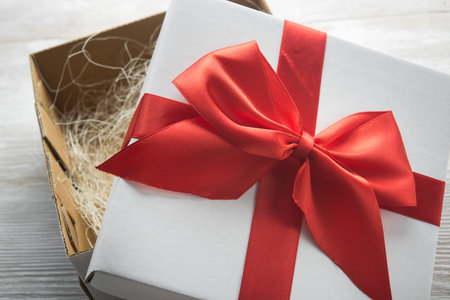 white present box with red ribbon bow