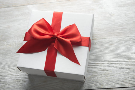 white present box with red ribbon bow