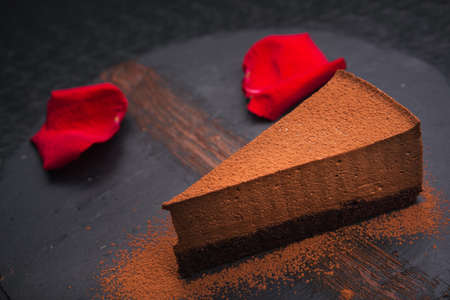chocolate cake with red rose petalsの写真素材