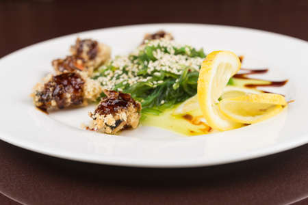 fresh chuka seaweed salad with mussels on white plateの写真素材