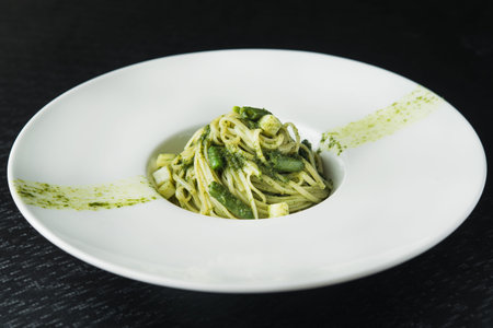 tasty pasta with asparaguson white plateの写真素材