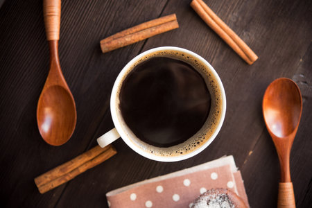white coffee cup on brown wood boardの写真素材