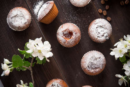 delicious pastries cakes with blossom flower on brown tableの写真素材