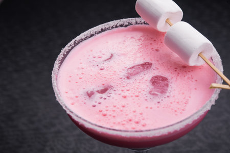 Strawberry cocktail with marshmallow on background