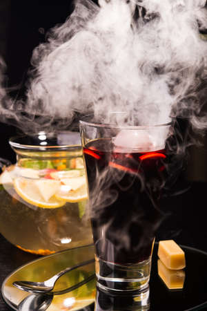 hot mulled wine with fume on a black backgroundの写真素材
