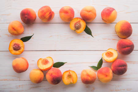 a lot of fresh peaches on a white tableの写真素材