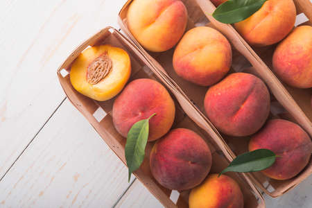 a lot of fresh peaches on a white tableの写真素材