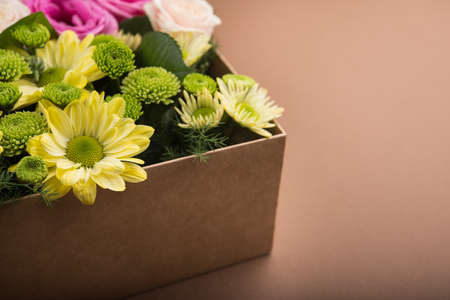 Gift box with flowers on vintage brown backgroundの写真素材