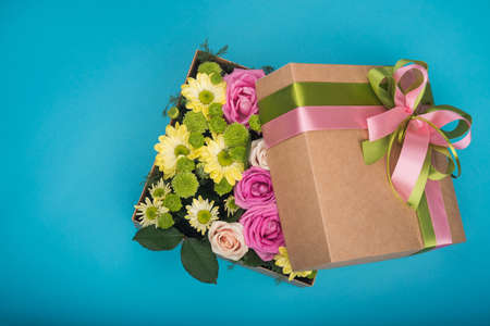 beautiful gift box with flowers on blue backgroundの写真素材