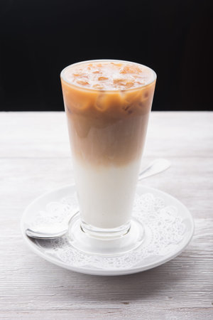 morning cappuccino in glass on white table