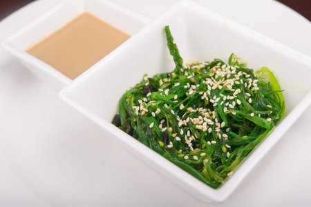 delicious fresh seaweed salad on white dishの写真素材