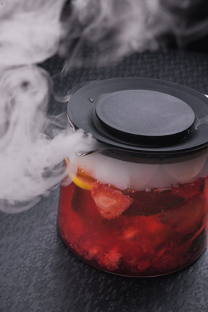strawberry tea in teapot with fume