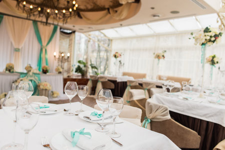 banqueting hall. serving table. decorated wedding chairs in row. wedding luxury party place. restaurant interior