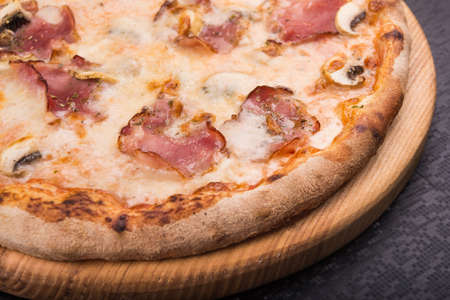 tasty italian pizza with bacon and mushrooms. fast food snackの写真素材