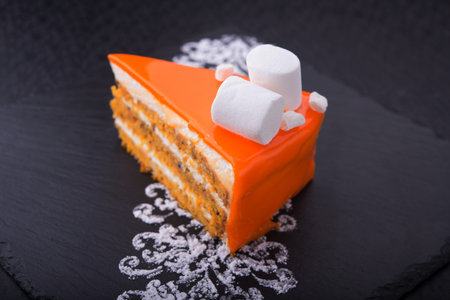 tasty piece of cake on stone slate. restaurant dessert on the pitch