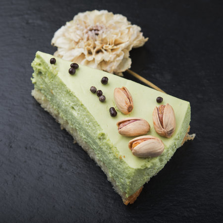 tasty piece of peanut cake on stone slate. restaurant dessert on the pitchの写真素材