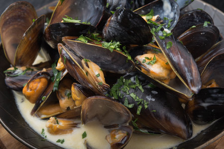 seafood mussels on pan with cream sauce.