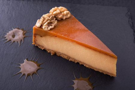 tasty piece of cake on stone slate. restaurant dessert on the pitchの写真素材