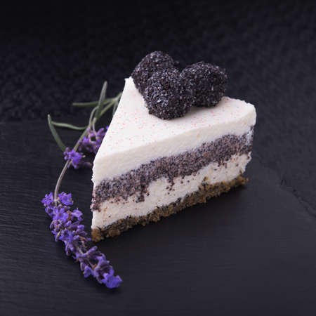 unusual lavender flower cake sliced on stone slate. restaurant foodの写真素材