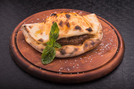 hot pita bread with meat on wooden board