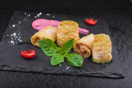 delicious stuffed zucchini with meat on stone slate. restaurant food