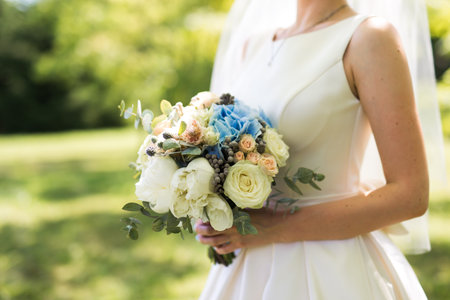 closeup photo of bride holding a flower bouquet.