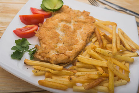 hearty breakfast with boiled potatoes and chicken chop.
