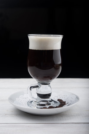 black coffee in glass on wood tableの写真素材