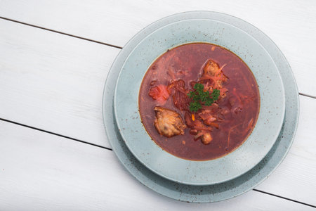 ukrainian soup borsch on a white wood table