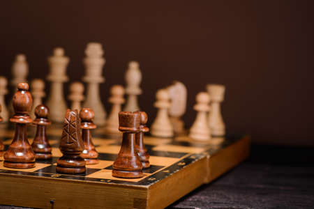 wood chess pieces on board game. brown vintage backgroundの写真素材