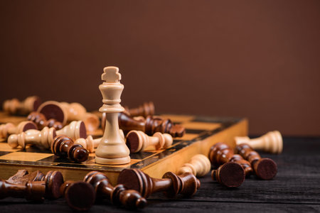 wood chess pieces on board game. brown vintage backgroundの写真素材