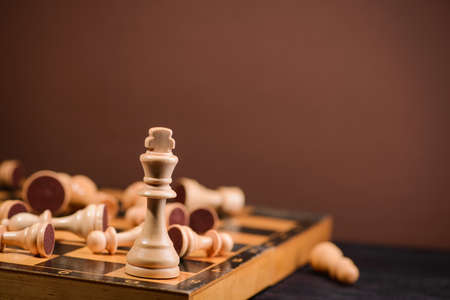 wood chess pieces on board game. brown vintage backgroundの写真素材